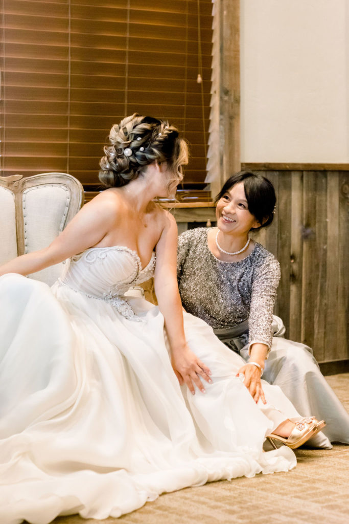 bride getting ready with mother