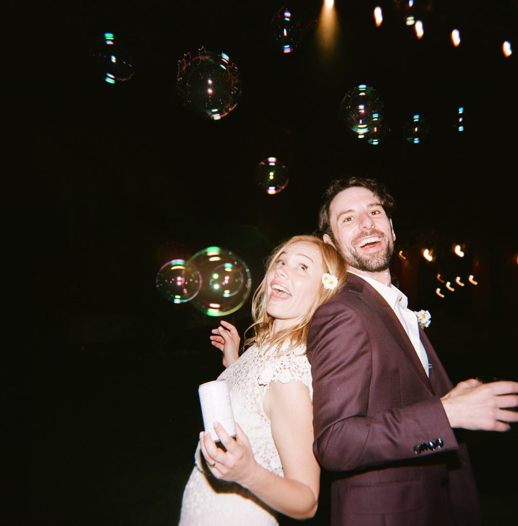 bride and groom dance with bubbles