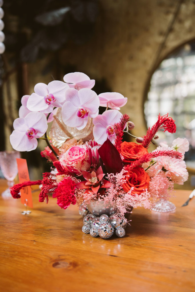 disco inspired wedding reception at Millwick in DTLA with disco balls in pink orchid centerpieces