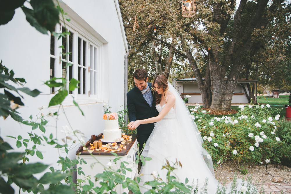 Rustic elegant styled wedding shoot, cake cutting