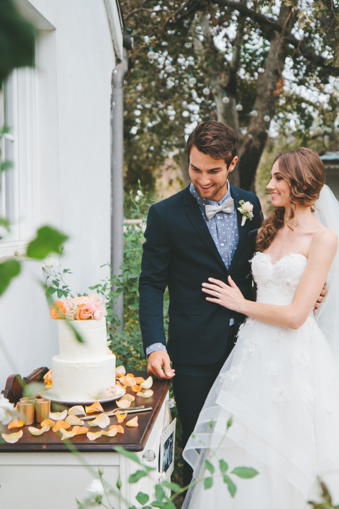 Rustic elegant styled wedding shoot, bride and groom cake cutting