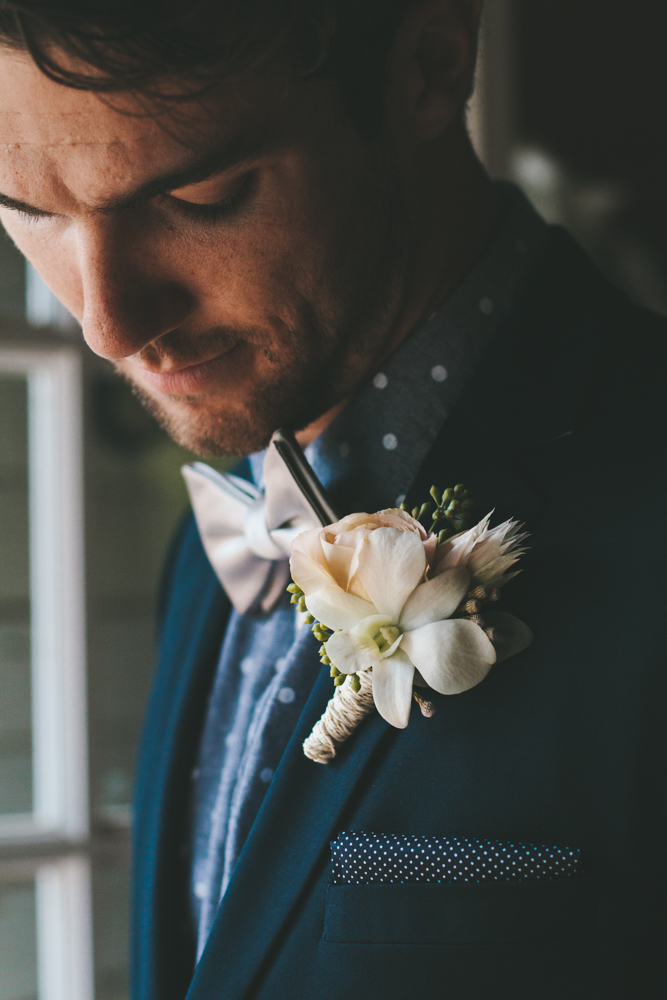 Rustic elegant styled wedding shoot, from with peach and white flower boutonniere