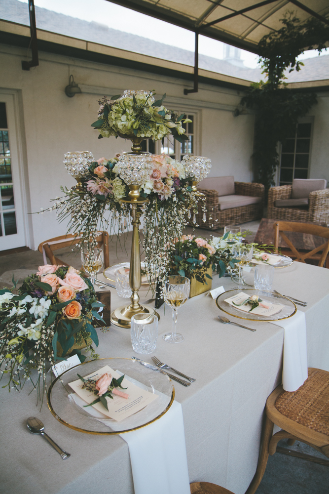 Rustic elegant styled wedding shoot, vintage vases with peach floral centerpieces