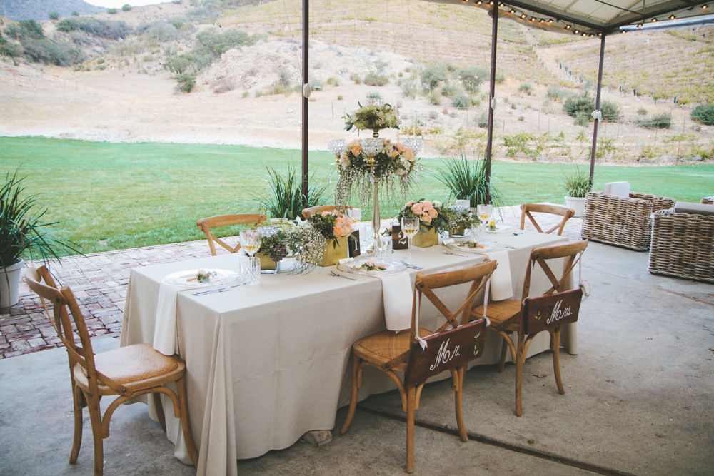 Rustic elegant styled wedding shoot, reception with vintage vases and peach floral centerpieces