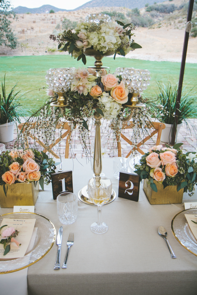 Rustic elegant styled wedding shoot reception with vintage vases and peach floral centerpieces