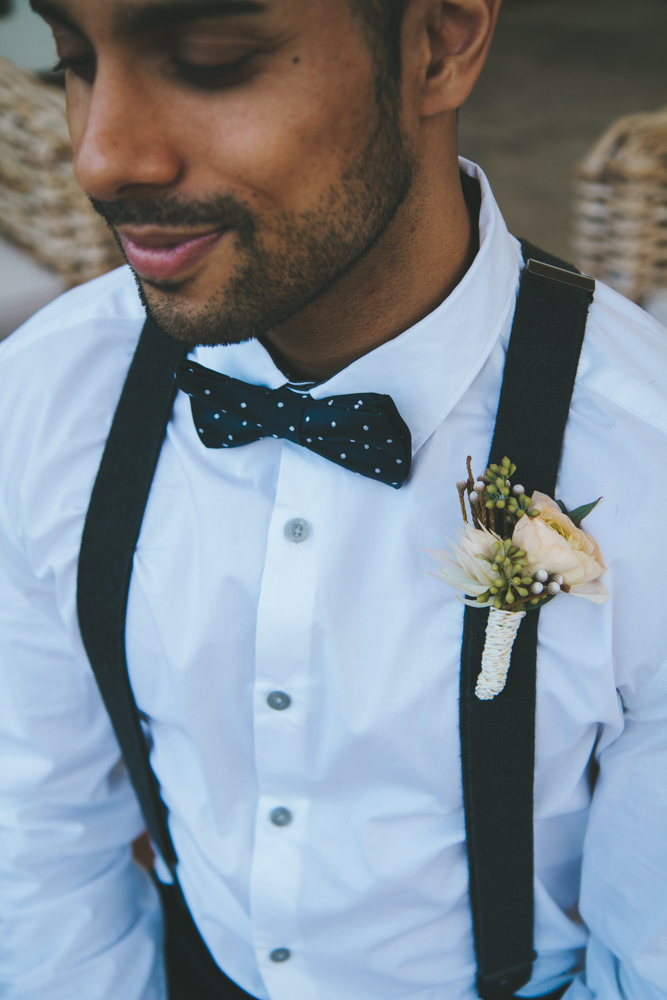 Rustic elegant styled wedding shoot, groomsmen with suspenders and rose boutonniere