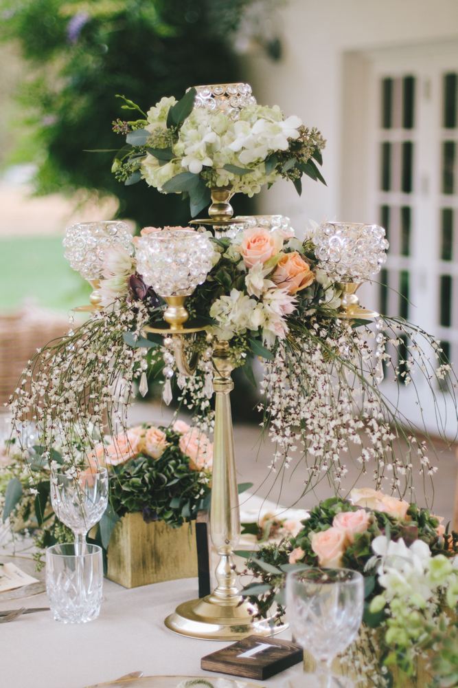 Rustic elegant styled wedding shoot, vintage vases with peach floral centerpiece