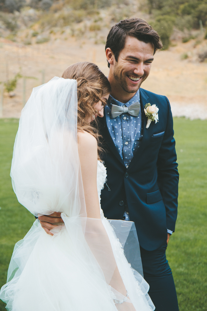 Rustic elegant styled wedding shoot, bride and groom portrait shot, groom wearing blue suit with bowtie