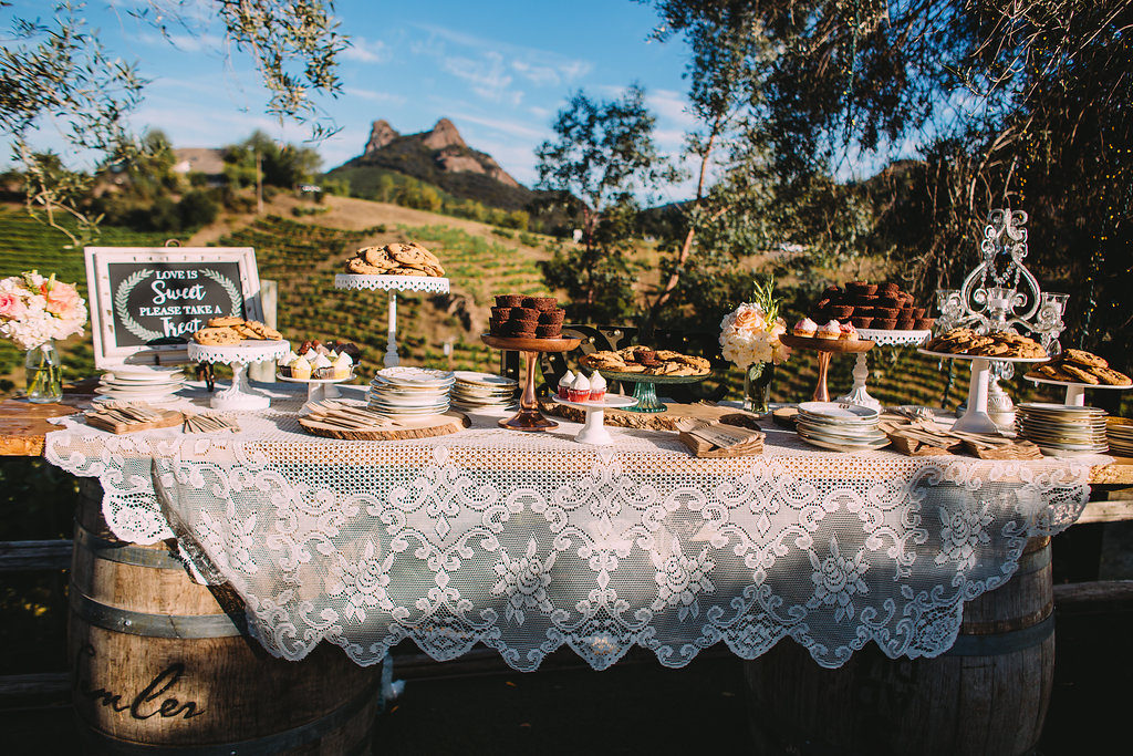 Saddlerock Ranch wedding reception dessert display with vintage lace table cloth