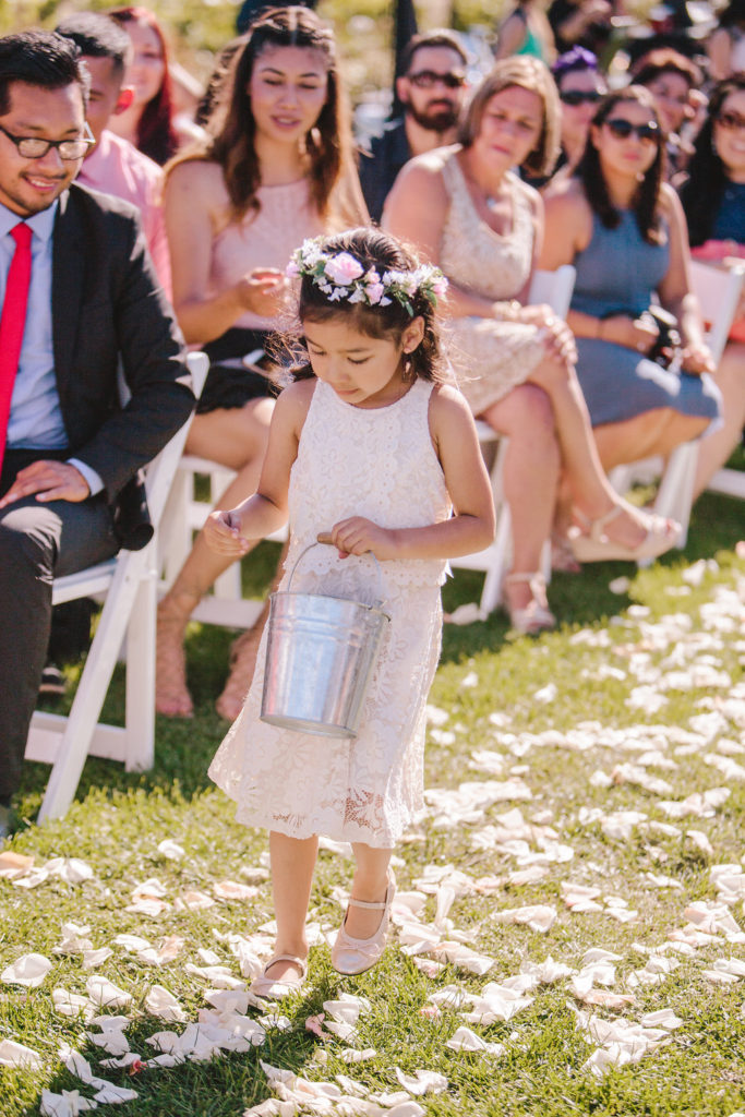 Saddlerock Ranch wedding ceremony with flower girl carrying petals in bucket