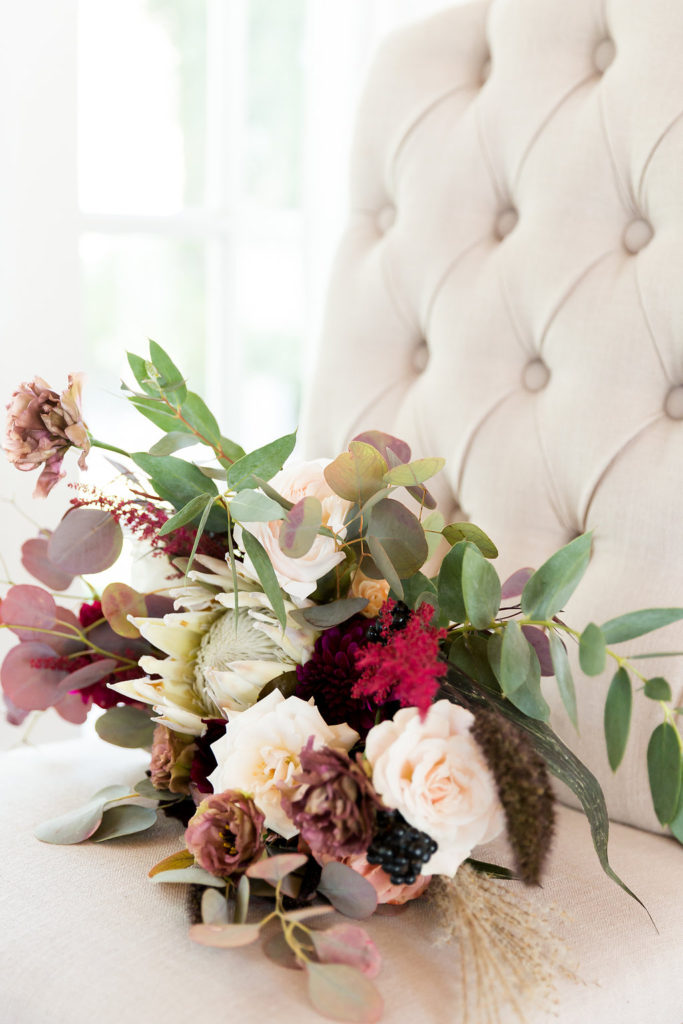Boho wedding bouquet with protea and burgundy florals