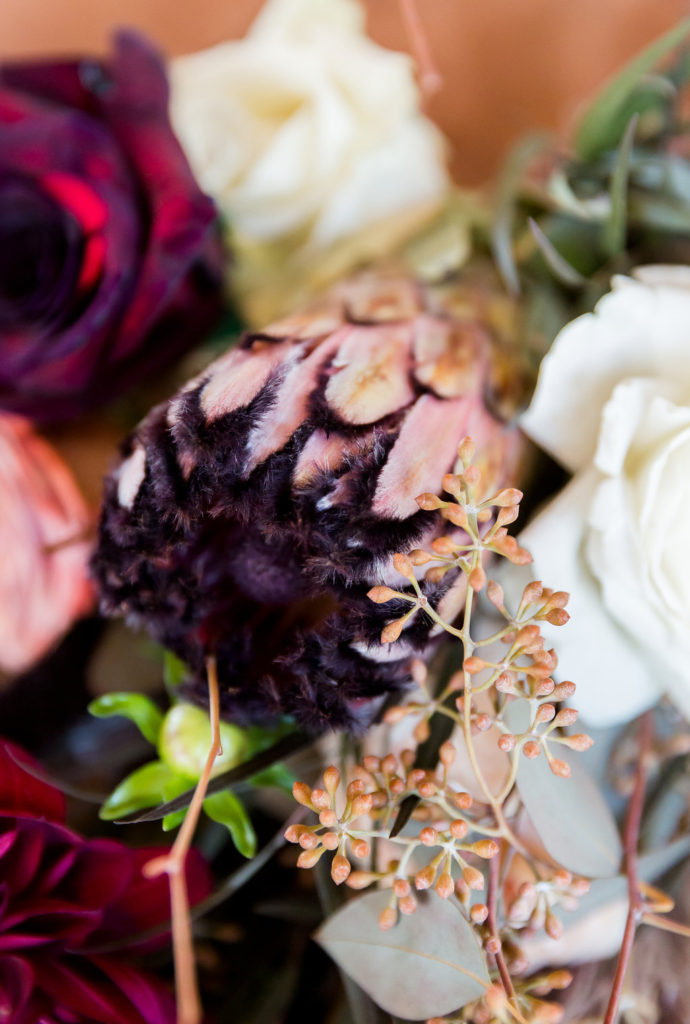 Boho wedding flowers and bouquet with protea, pampas grass and burgundy florals
