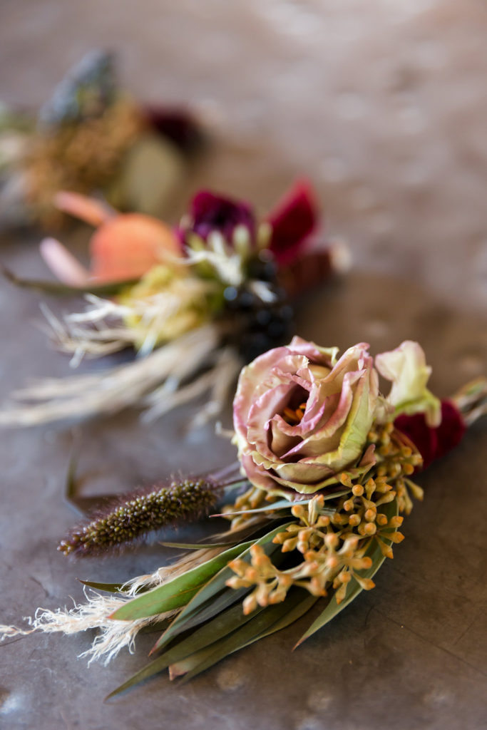 boho wedding boutonnieres with pampas grass and dark flowers at Triunfo Creek Vineyards