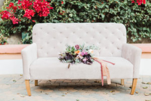 Party Pieces by Perry ivory sofa with bridal bouquet