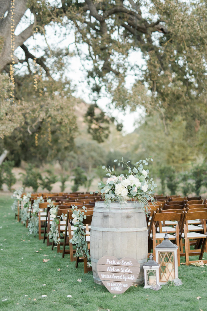 Triunfo Creek Vineyard wedding, wine barrel decorations, white floral arrangements