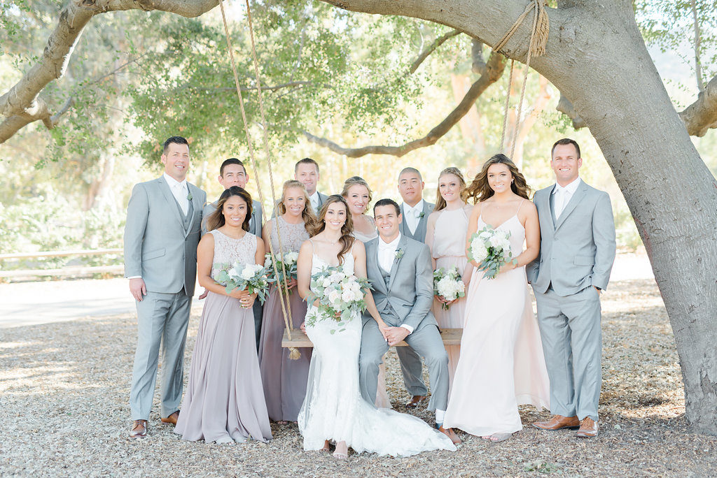 Triunfo Creek Vineyard wedding party group photo on oak swing