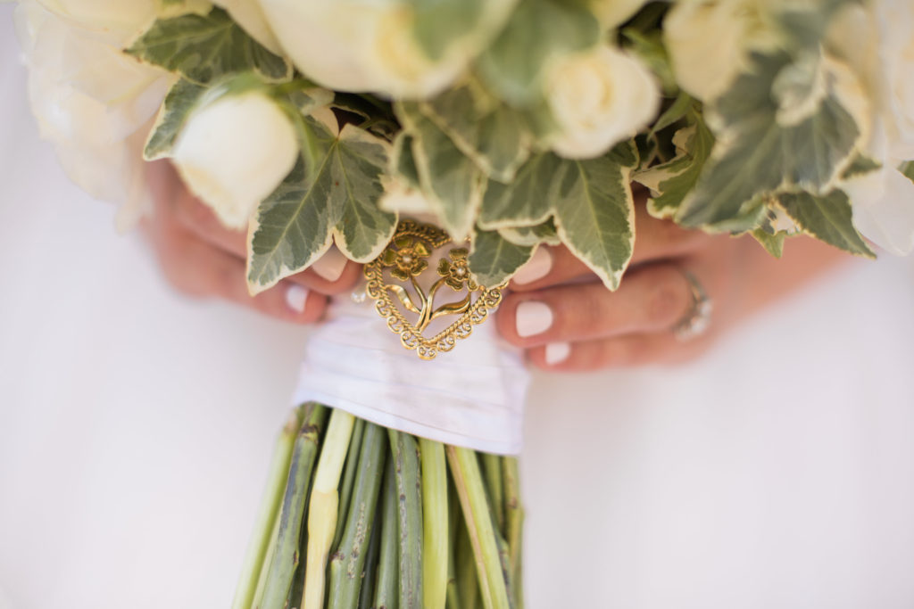 wedding at Sogno del Fiore winery in Santa Ynez, bride portrait shots with all white flower bouquet and family heirloom pin