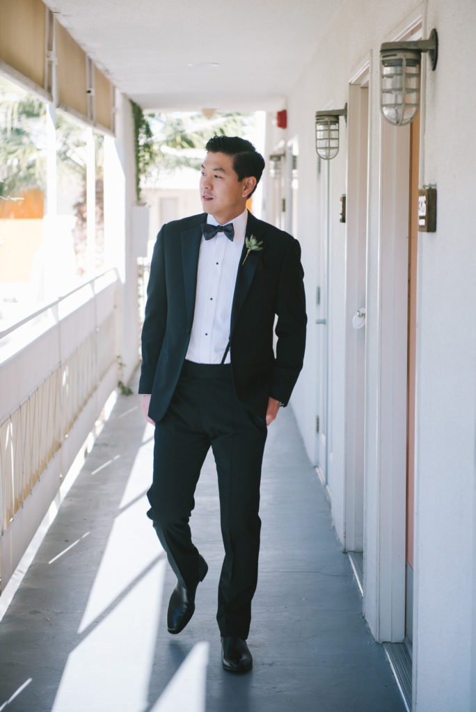 Ace Hotel in Palm Springs groom wearing black suit with bowtie