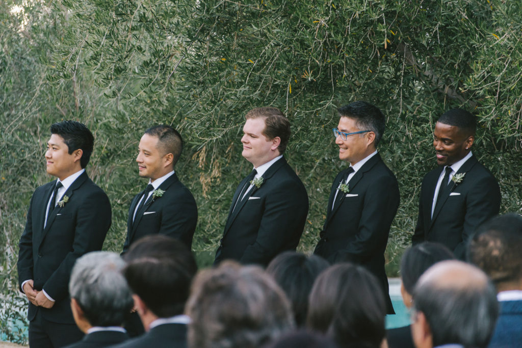 Ace Hotel wedding in Palm Springs wedding ceremony, groomsmen in black suits with succulent boutonniere
