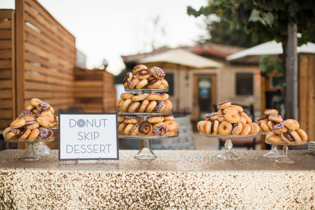 Sogno del fiore wedding reception in Santa Ynez modern donut dessert table with gold sequin table cloth