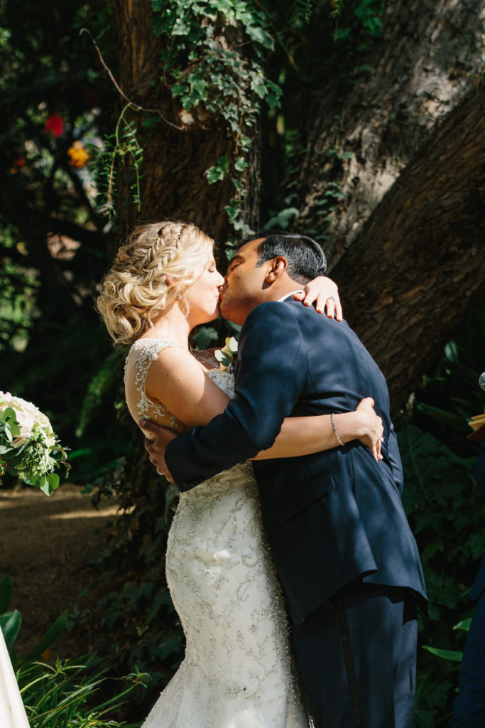 travel themed wedding at Mountain Mermaid, multicultural ceremony, bride and groom first kiss