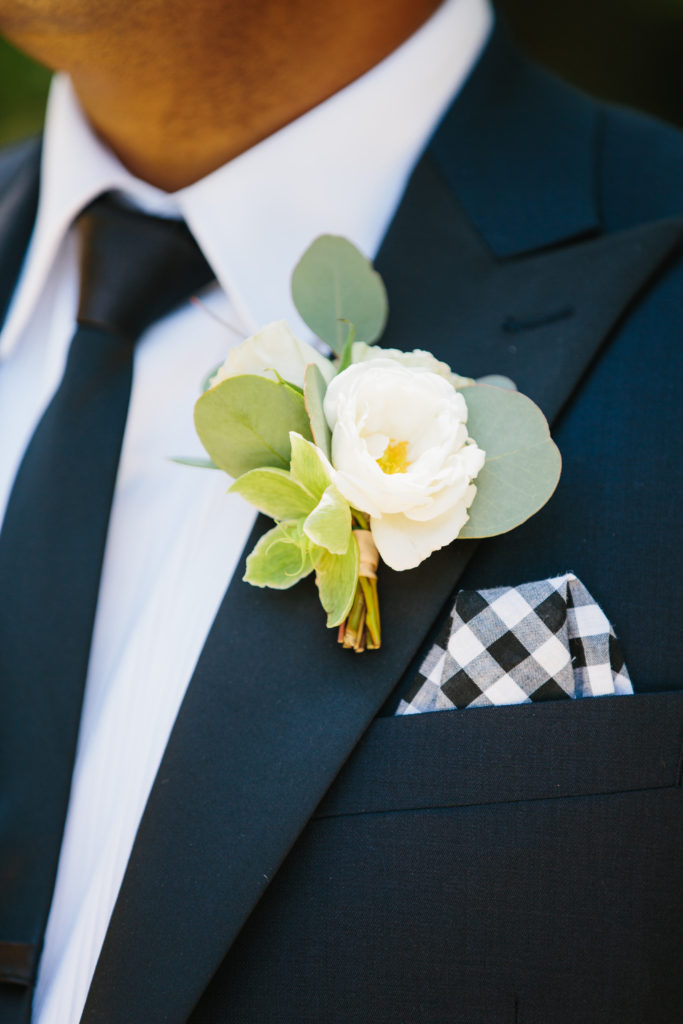 travel themed wedding at Mountain Mermaid, simple white rose boutonniere