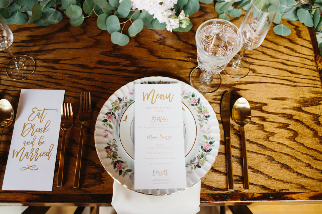 travel themed wedding at Mountain Mermaid, multicultural wedding, farm reception tables with mismatched vintage china and gold menu cards