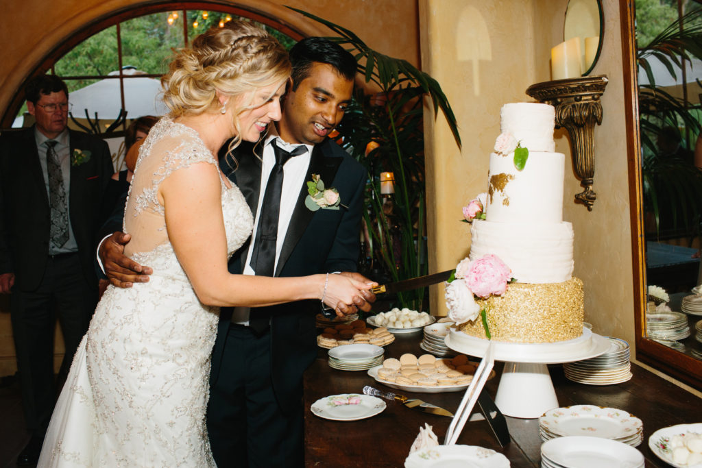 travel themed wedding at Mountain Mermaid, multicultural wedding, bride and groom cutting cake
