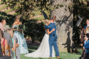 Elegant fall wedding ceremony at Triunfo Creek Vineyards, bride and groom first kiss
