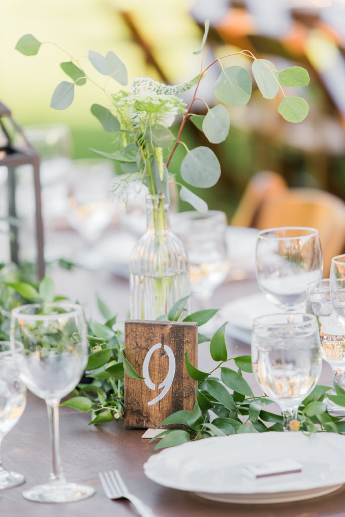 Elegant fall wedding reception at Triunfo Creek Vineyards, wooden table numbers