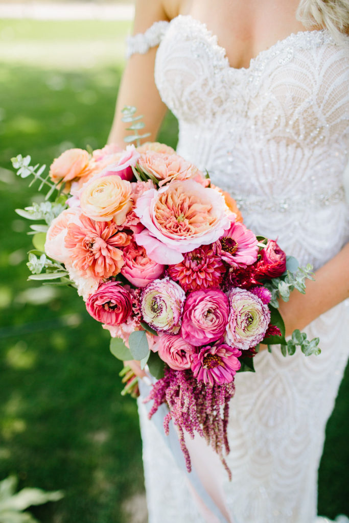 bridal bouquet with pink and orange flowers at this bright vineyard wedding at Triunfo Creek Vineyards