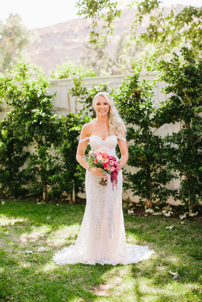 bridal portrait in off shoulder beaded wedding dress with pink bridal bouquet at the bright vineyards wedding at Triunfo Creek Vineyards in Agoura Hills
