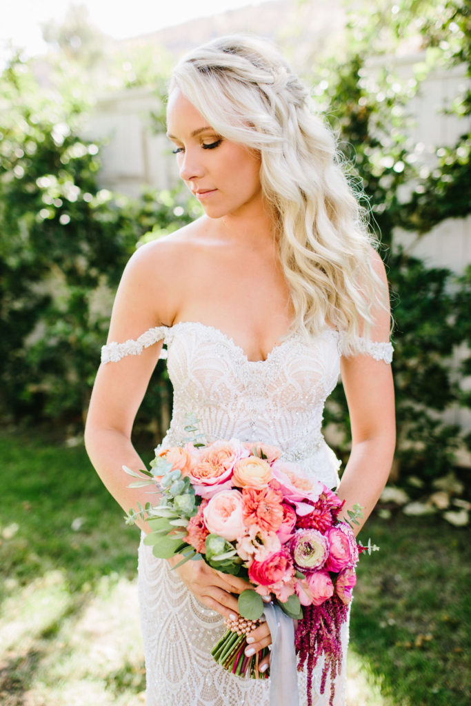 bridal portrait with off shoulder beaded wedding dress and pink floral bridal bouquet at this bright vineyard wedding at Triunfo Creek Vineyards