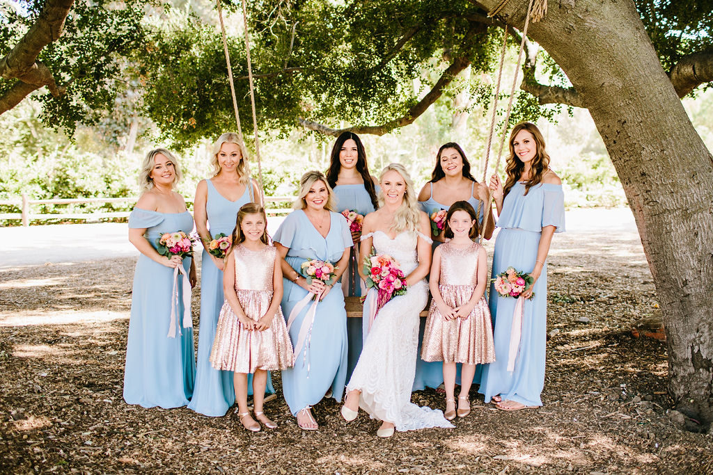 Bride with bridesmaids and flower girls at bright vineyard wedding at Triunfo Creek Vineyards