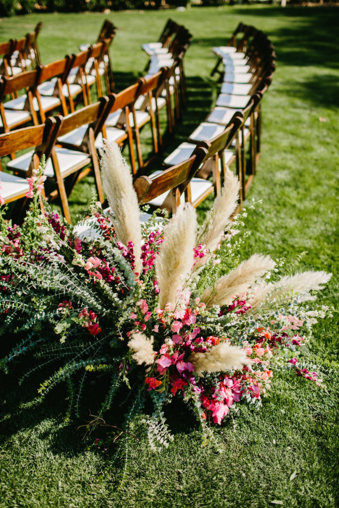 Eucalyptus and pampas grass with pink flowers at wedding ceremony at Triunfo Creek Vineyards