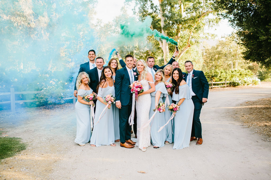 bride and groom with wedding party portrait photos with colorful smoke bombs at Triunfo Creek Vineyards