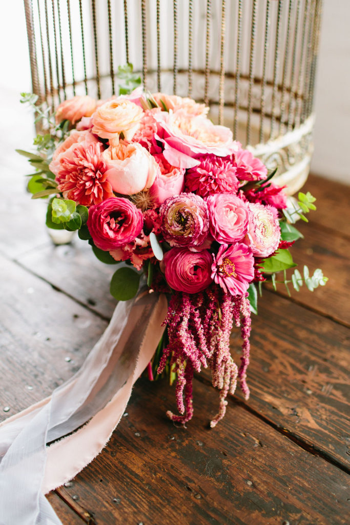 Bridal bouquet with bright pink flowers and pale pink ribbon