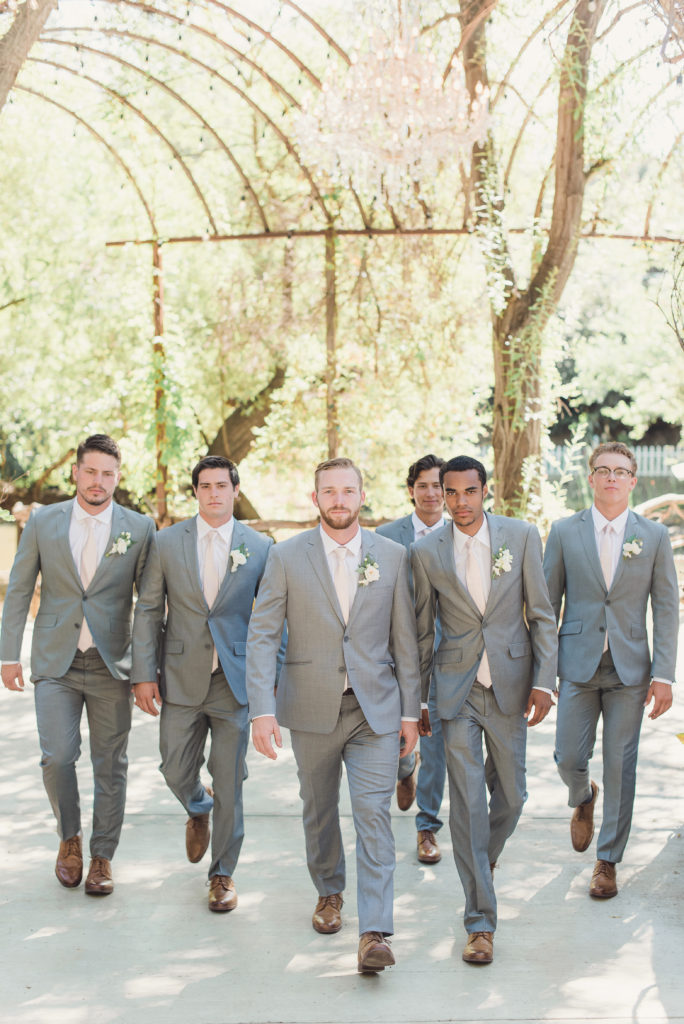 An emotional calamigos ranch wedding, groom and groomsmen in light grey suits and pale pink ties