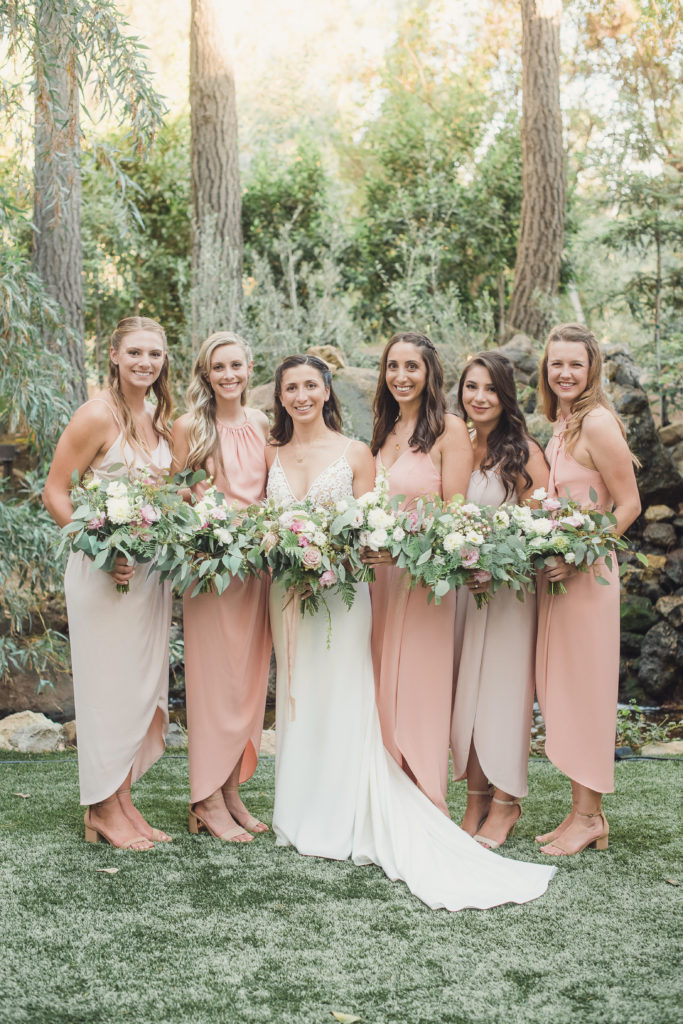 An emotional calamigos ranch wedding, bride and bridesmaids in ombre pink dresses