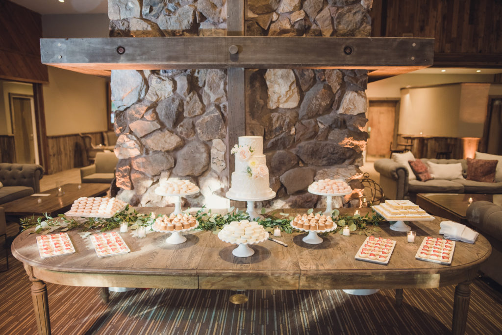 An emotional calamigos ranch wedding, reception tables, cake table with desserts