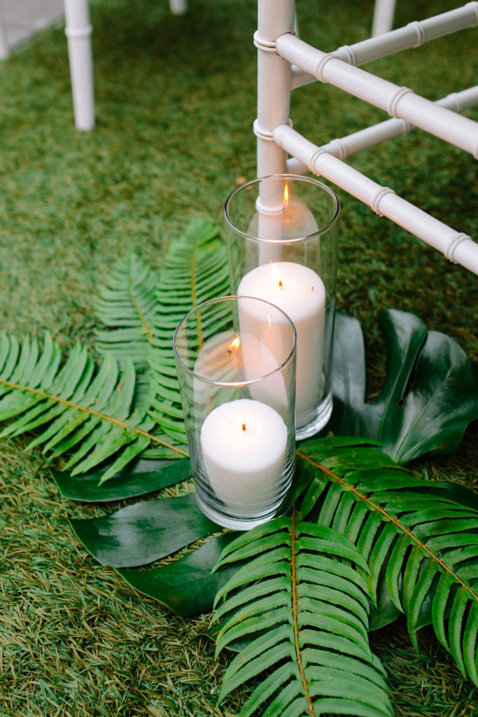 A glam and California infused wedding ceremony at Viceroy Santa Monica with monstera leaves and candles