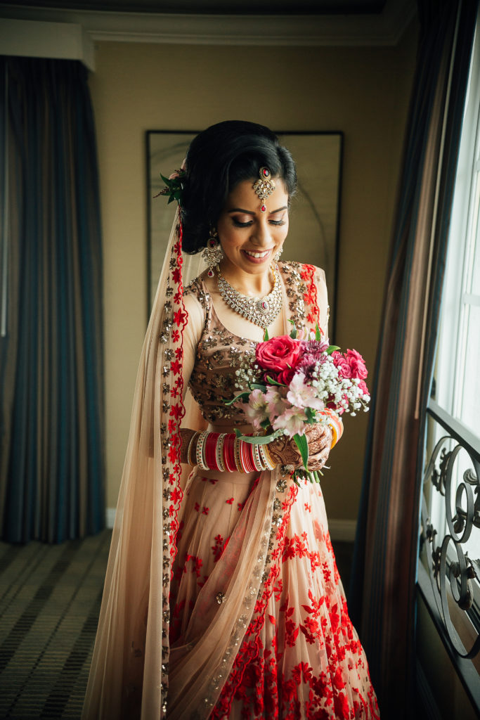 Stunning Indian Wedding in San Pedro, bride in gold and red wedding sari getting ready