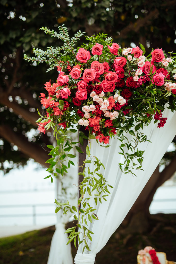 Stunning Indian Wedding in San Pedro, red and blush floral arch with draping