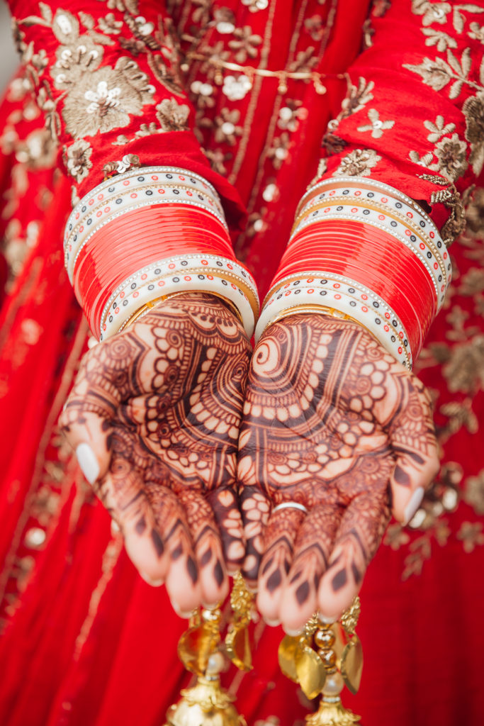 Stunning Indian Wedding in San Pedro, red bridal sari for sikh ceremony with henna tattoo