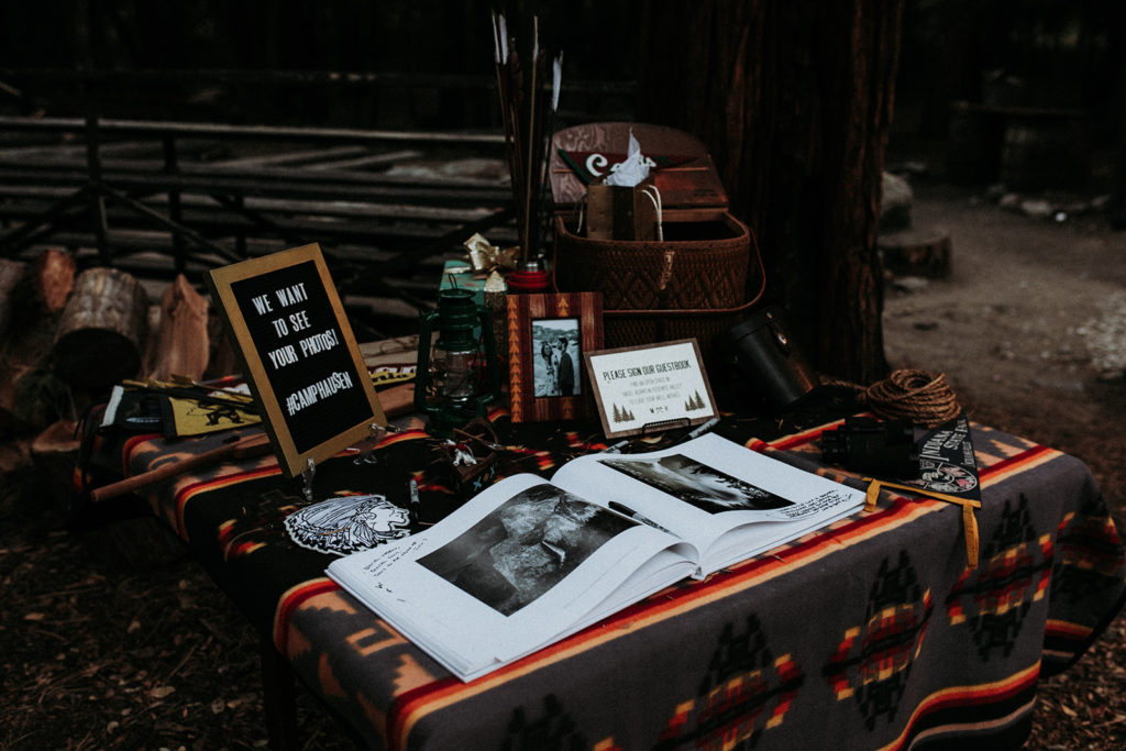Summer camp themed wedding in Big Bear at Camp Wasegan, forest themed wedding welcome table with guest book