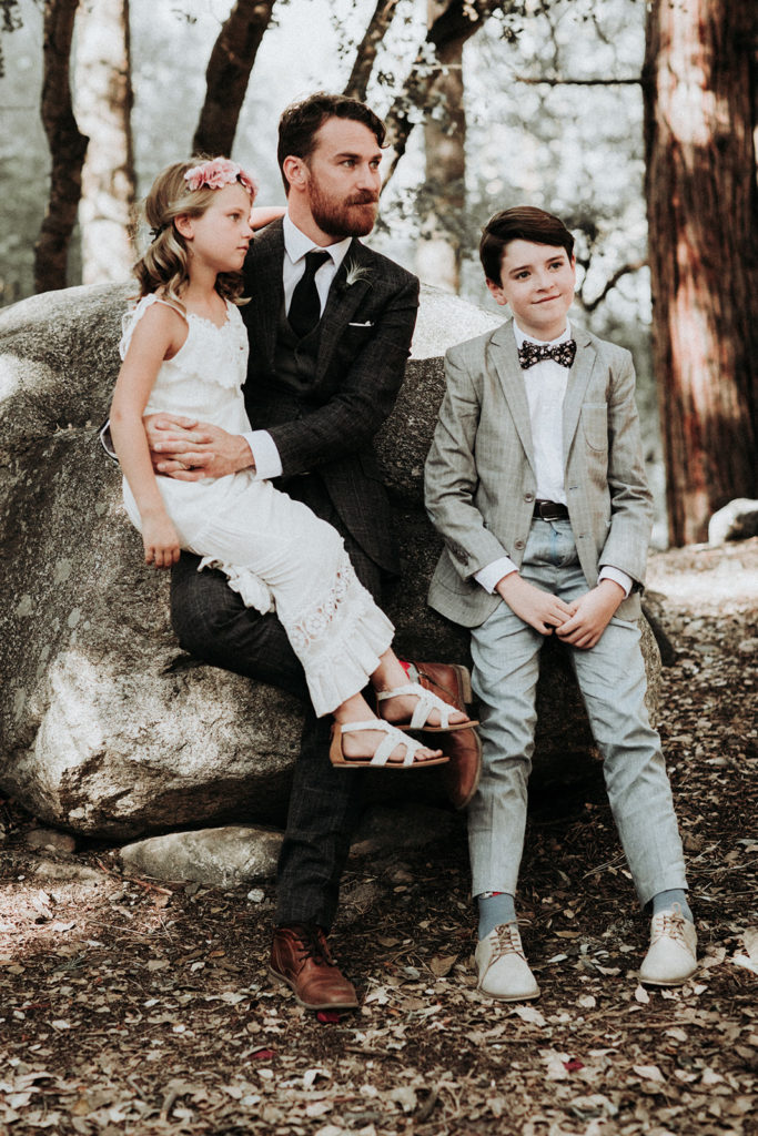 Summer camp themed wedding in Big Bear at Camp Wasegan, ring bearer with tie and bohemian flower girl