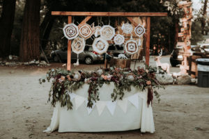 Summer camp themed wedding reception in Big Bear at Camp Wasegan, bohemian sweetheart table with dreamcatchers