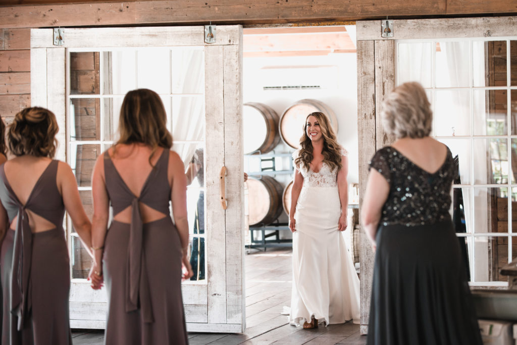 A simple and modern wedding at Triunfo Creek Vineyards, bride reveal to bridesmaids
