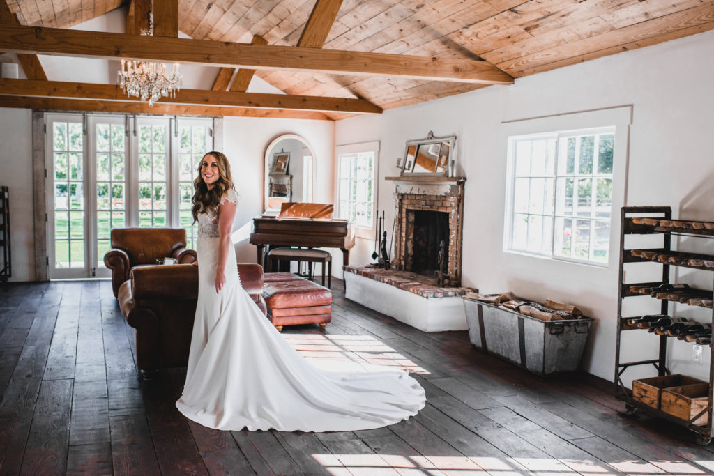A simple and modern wedding at Triunfo Creek Vineyards, bride with long train on simple wedding dress