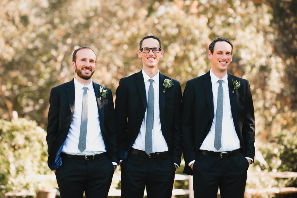 A simple and modern wedding at Triunfo Creek Vineyards, groom and groomsmen wearing black suits and blue ties